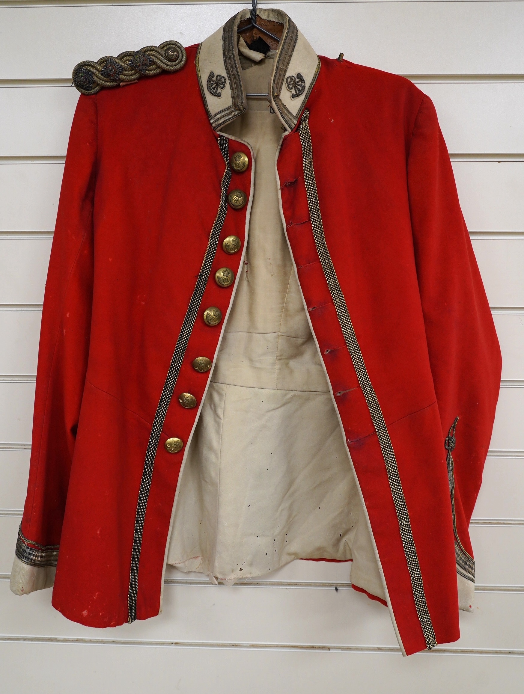 A Sixth Light Infantry officer’s uniform with epaulettes, comprising jacket and dress trousers. Condition - poor to fair, some staining and moth damage, etc.